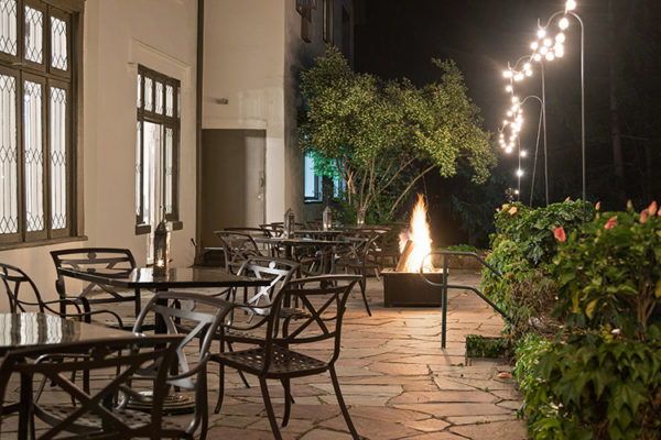 Outdoor Dining Area at night with fire pit